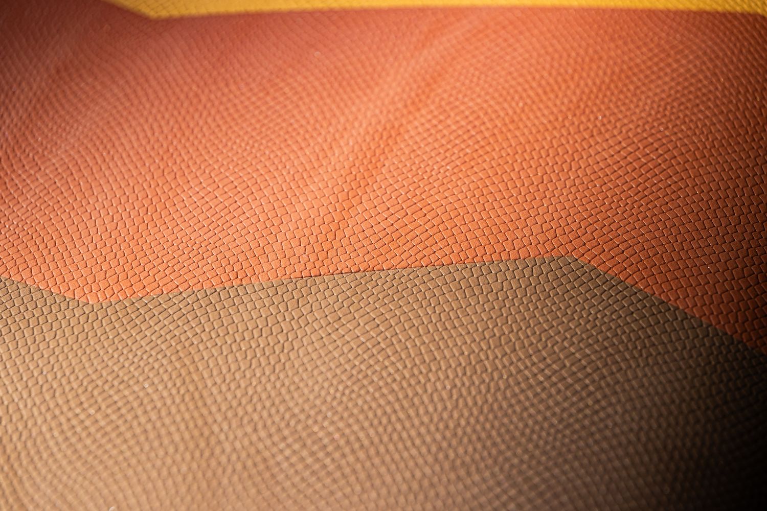 a close up of an orange and brown material