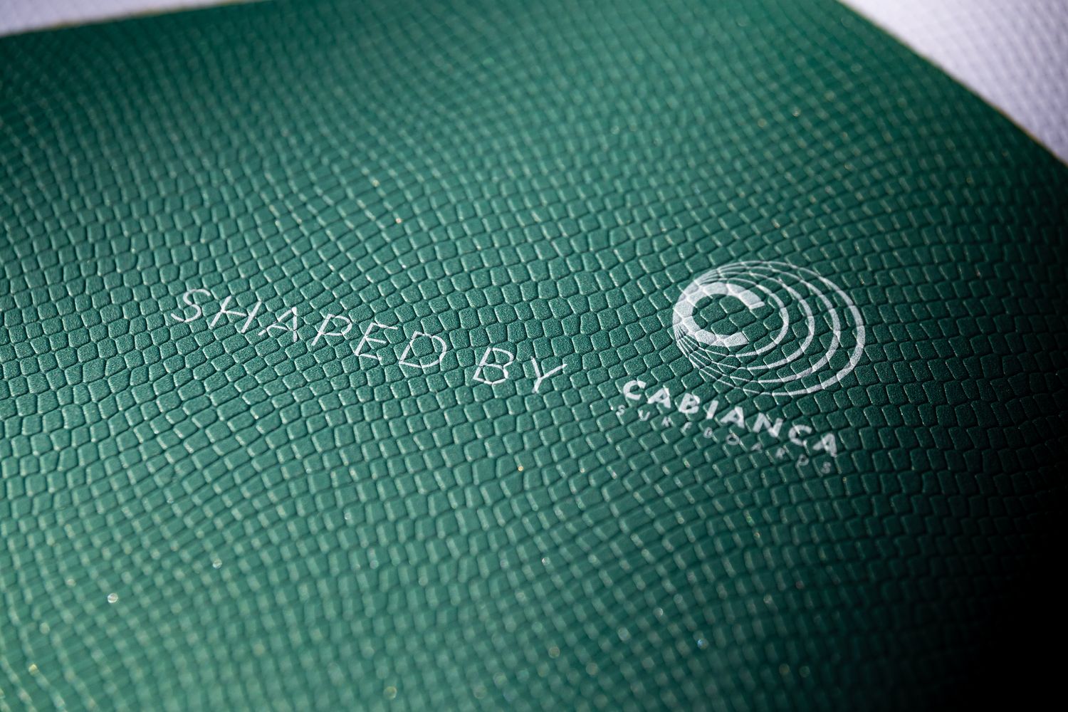 a close up of a green book with a logo on it